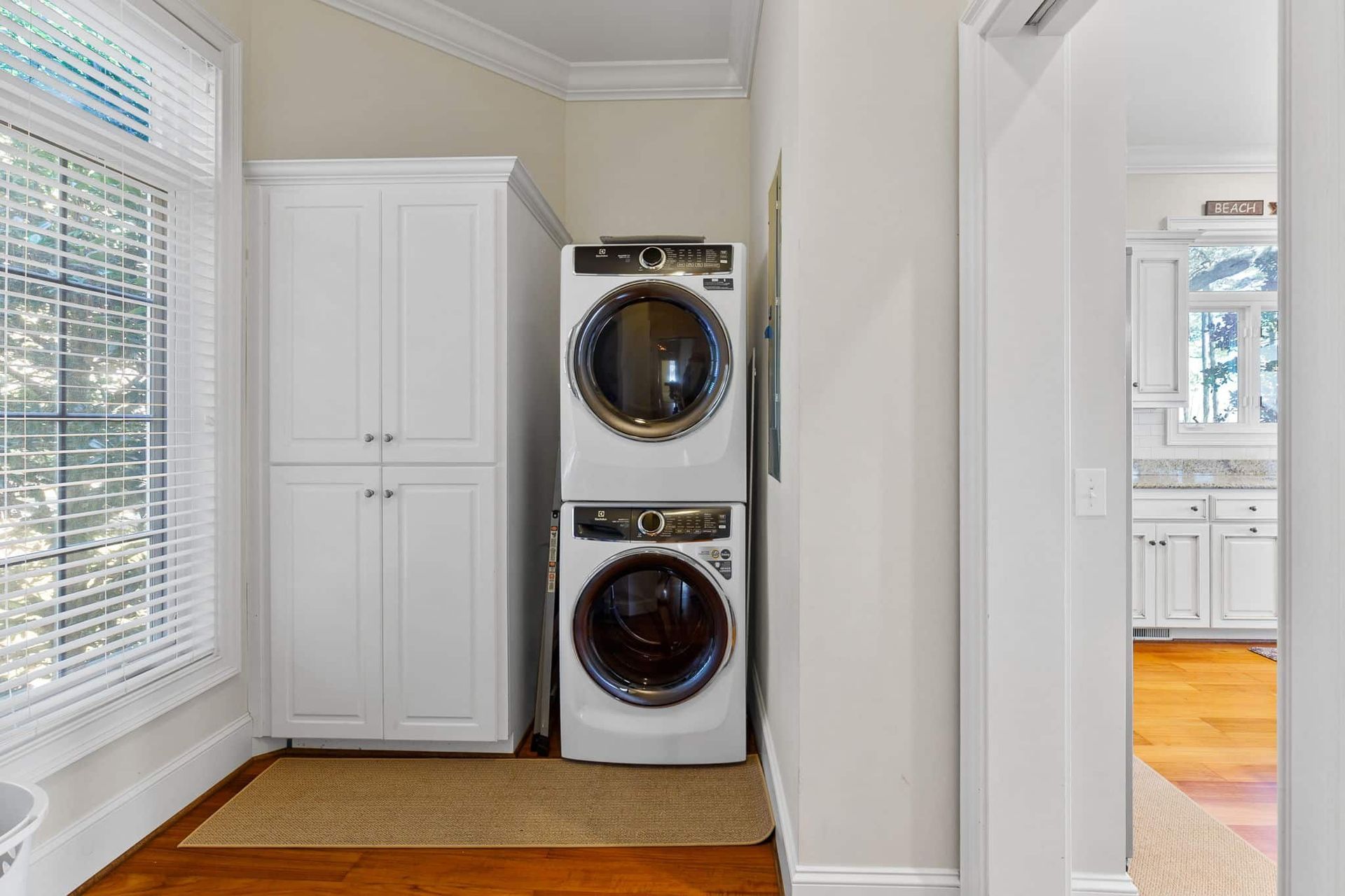 A laundry room with a washer and dryer stacked on top of each other.
