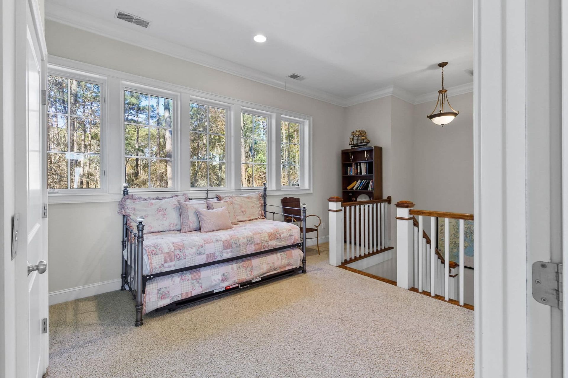 There is a day bed in the middle of the room.