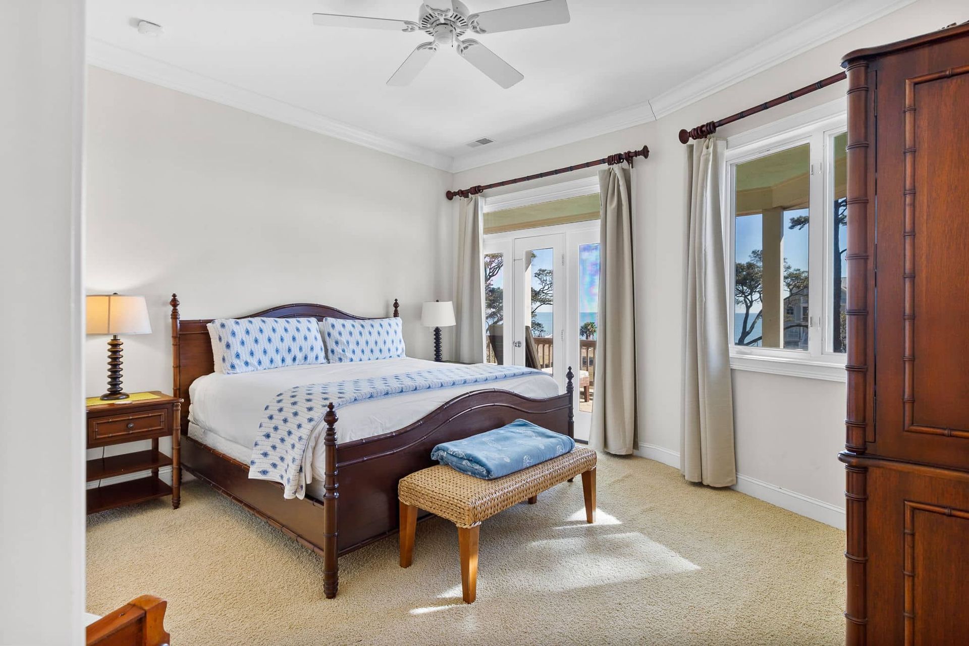 A bedroom with a king size bed and a ceiling fan.