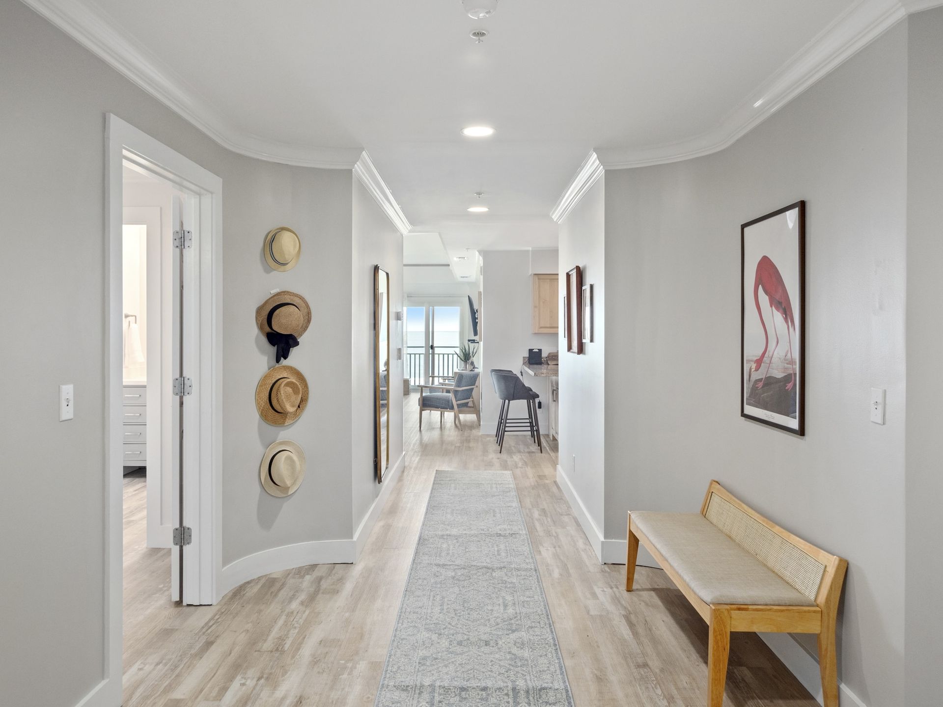 A hallway with a bench and a picture on the wall.
