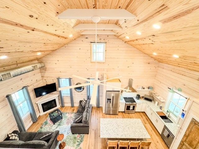 A screened in porch with a view of trees and the ocean