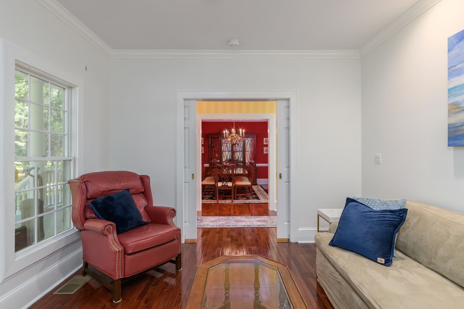 A living room with a couch , chair , and coffee table.