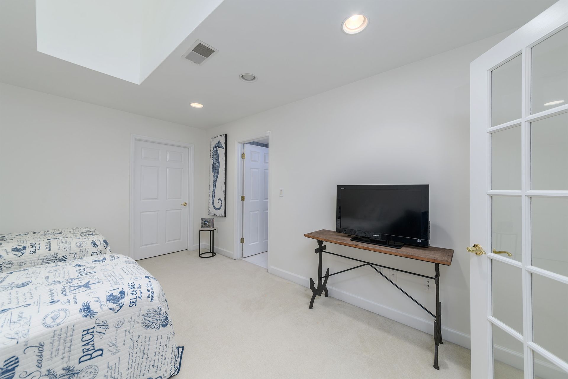 A bedroom with a bed and a television on a table.