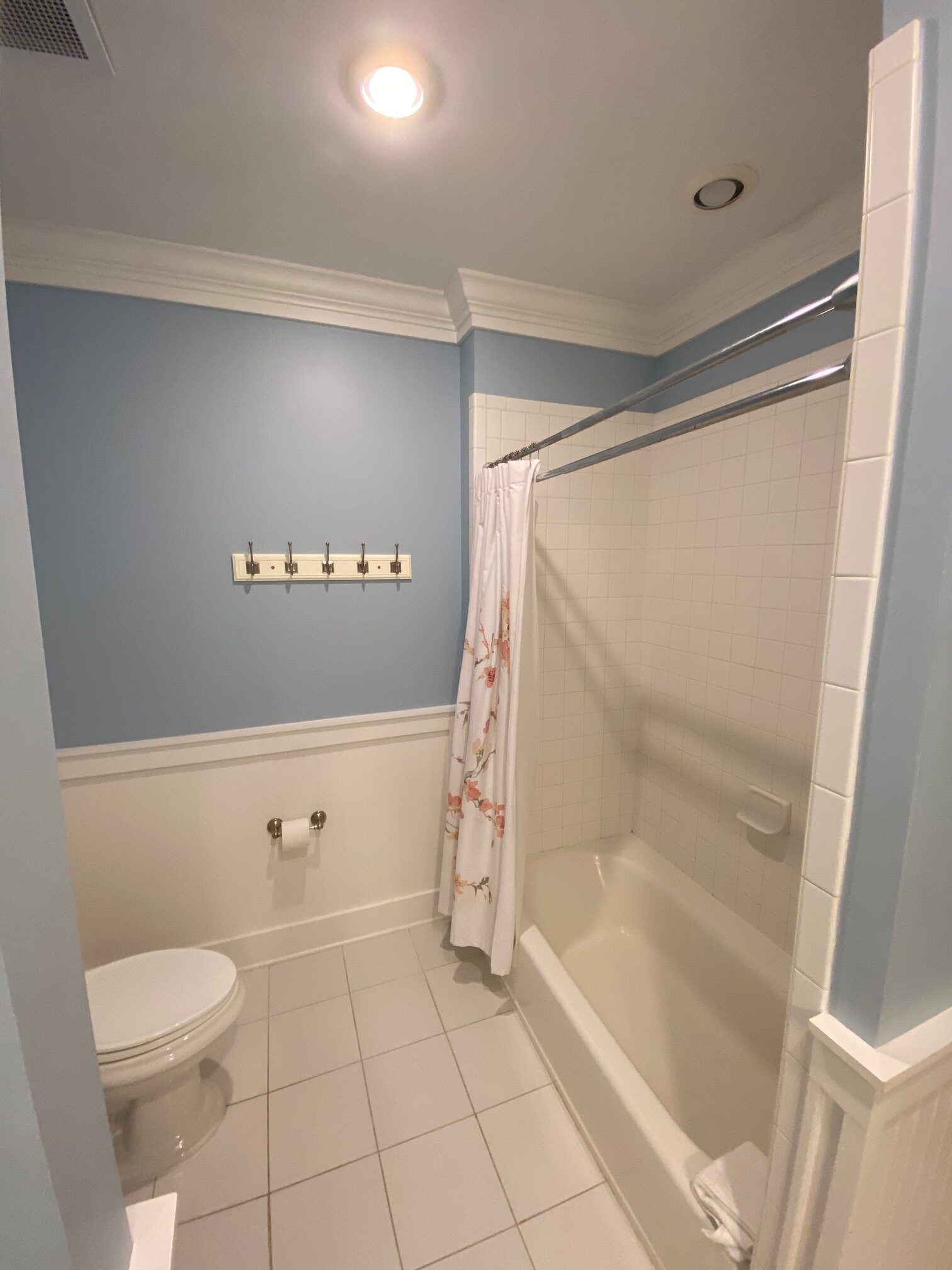 A bathroom with a toilet , shower and bathtub