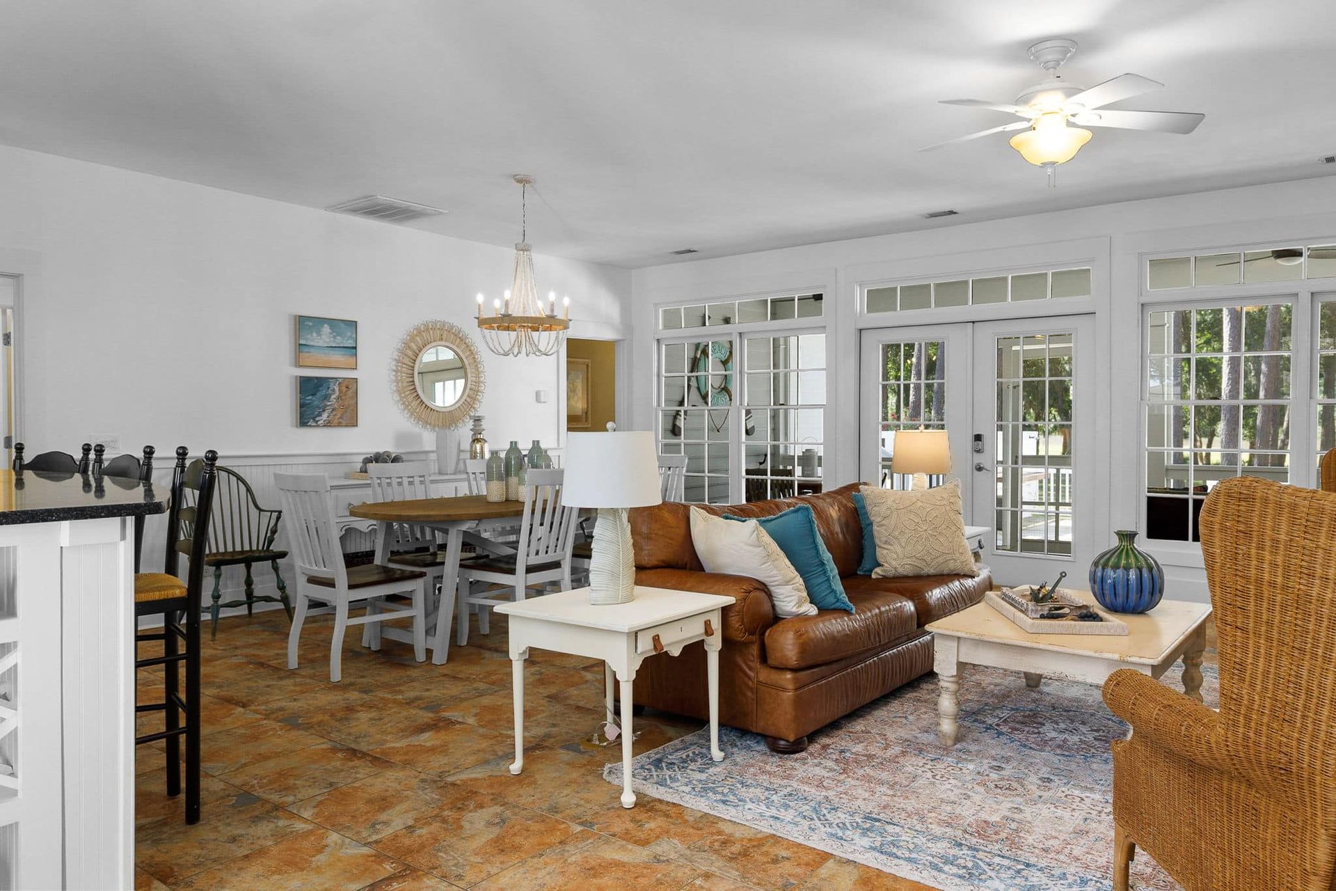 A living room filled with furniture and a ceiling fan.