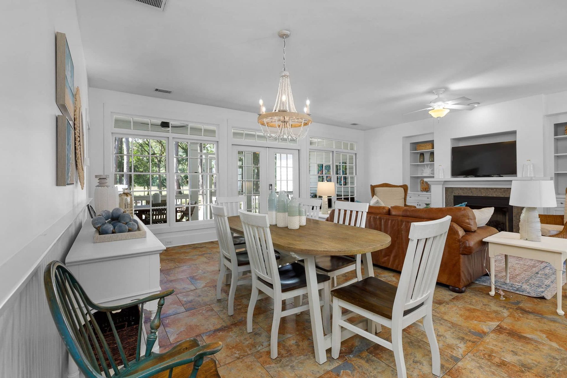 A living room with a table and chairs and a fireplace.