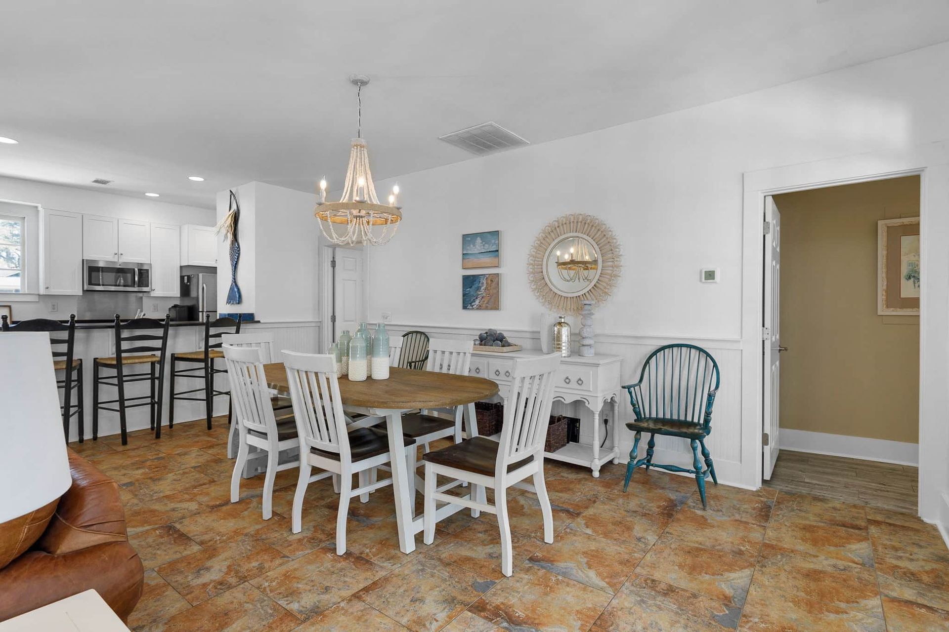 A dining room with a table and chairs and a chandelier.