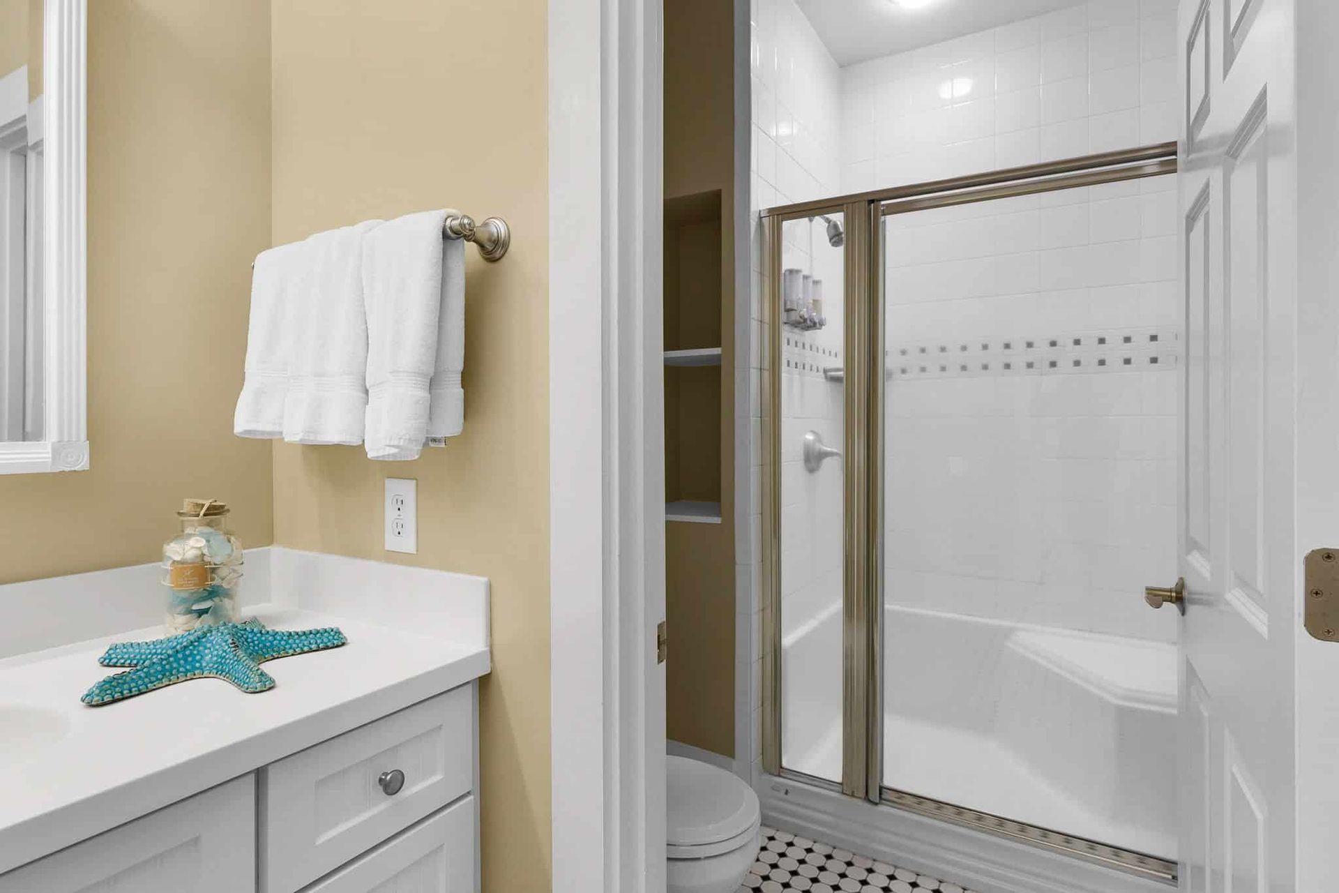 A bathroom with a sink , toilet , shower and bathtub.