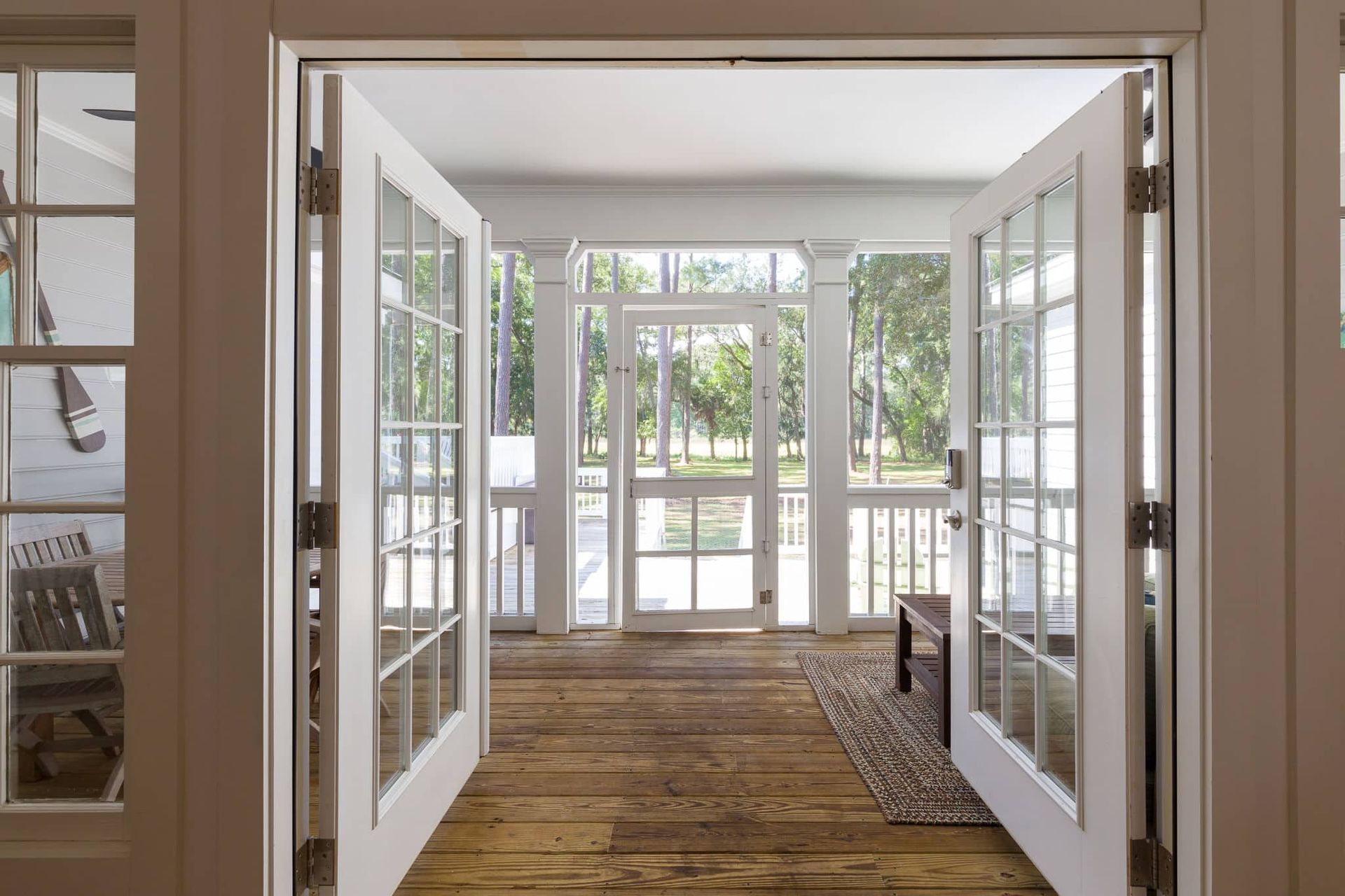 A room with a lot of windows and a wooden floor.