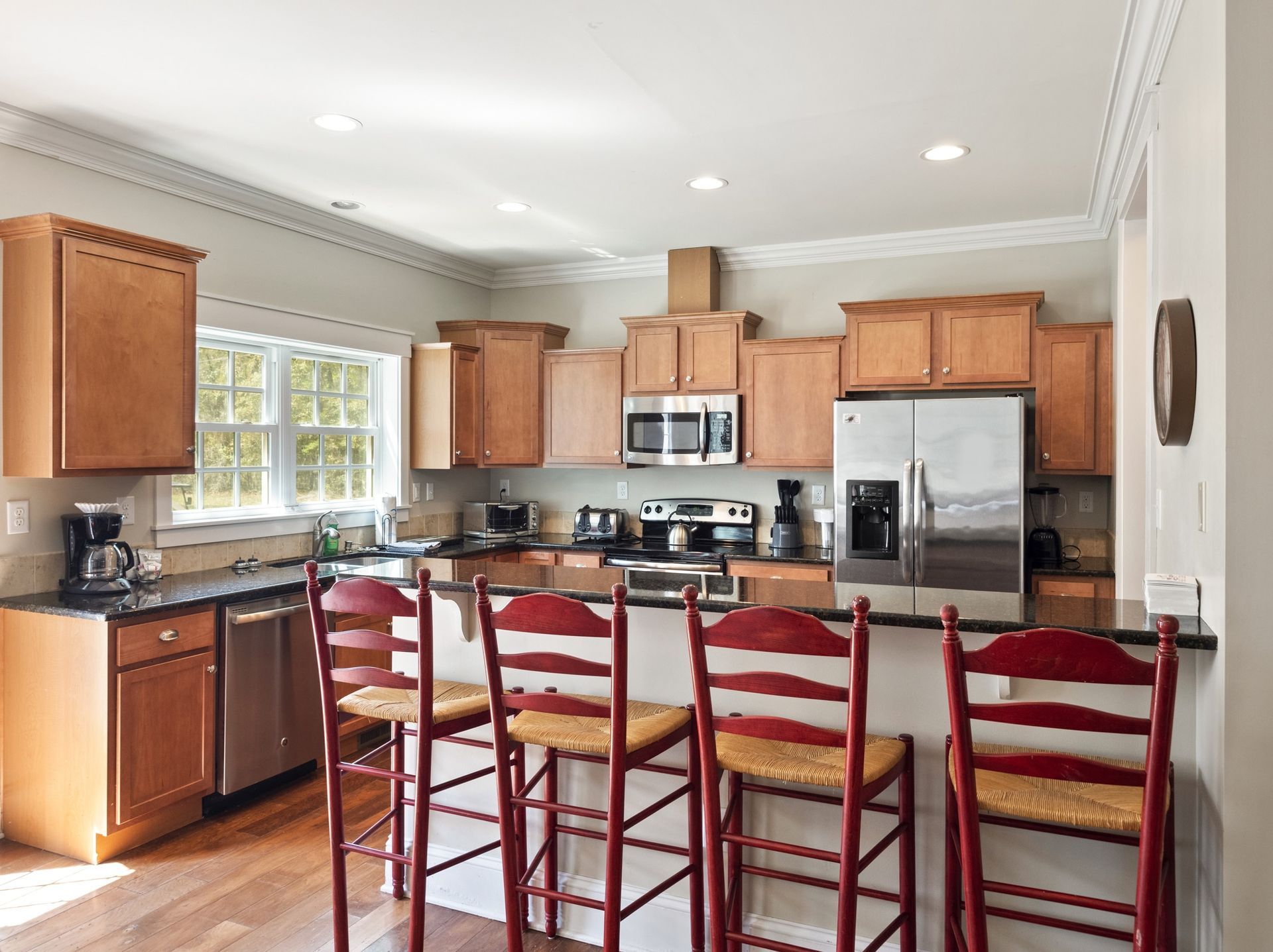 A kitchen with stainless steel appliances and wooden cabinets