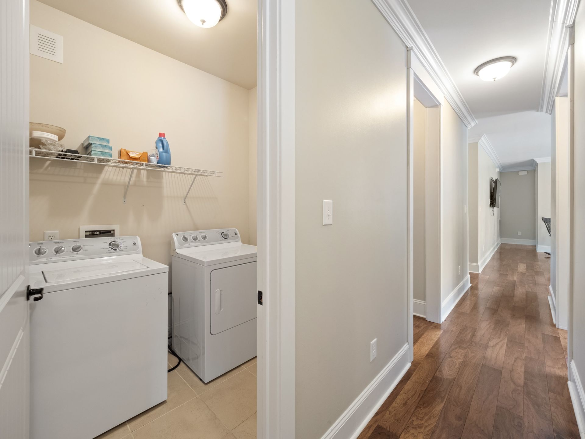 A laundry room with a washer and dryer in a hallway.