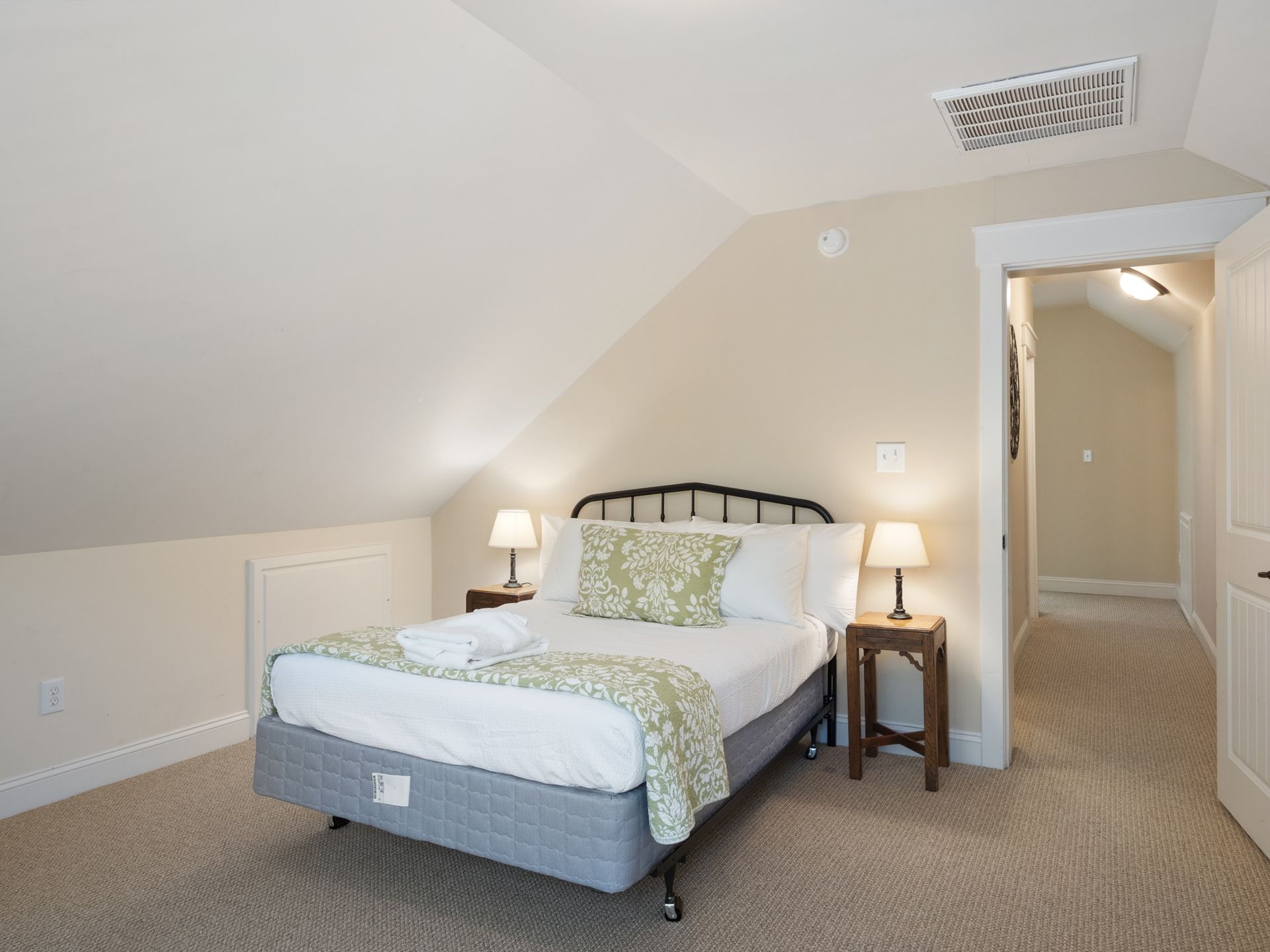 A bedroom with a king size bed and two nightstands