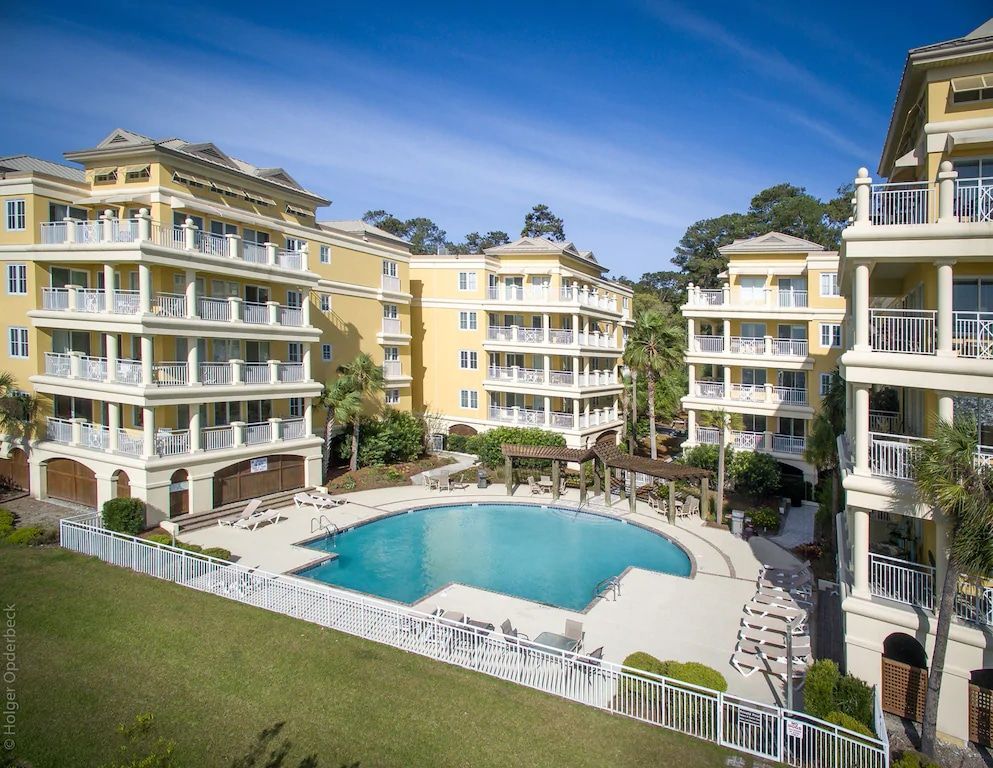 An aerial view of a large swimming pool surrounded by buildings.