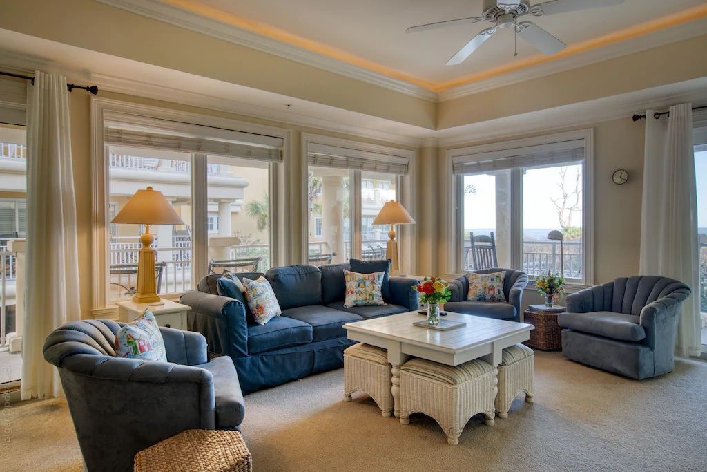 A living room filled with furniture and a ceiling fan.