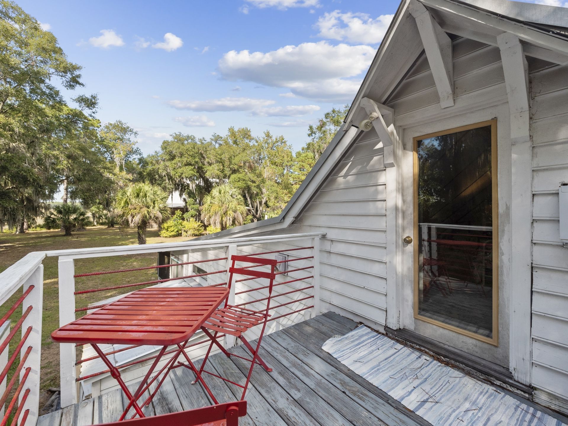 A small deck with a table and chairs on it