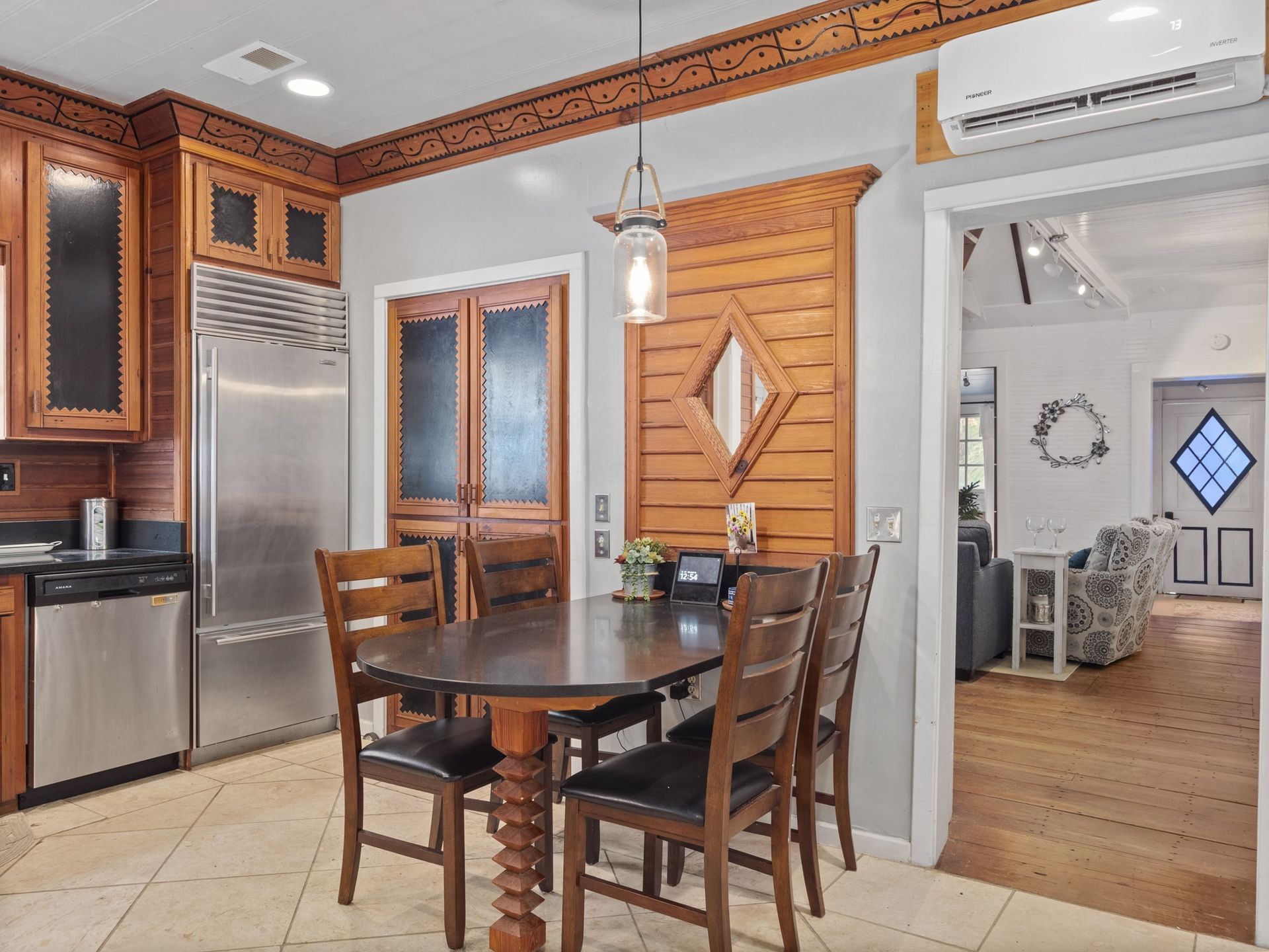 A kitchen with a table and chairs and a refrigerator