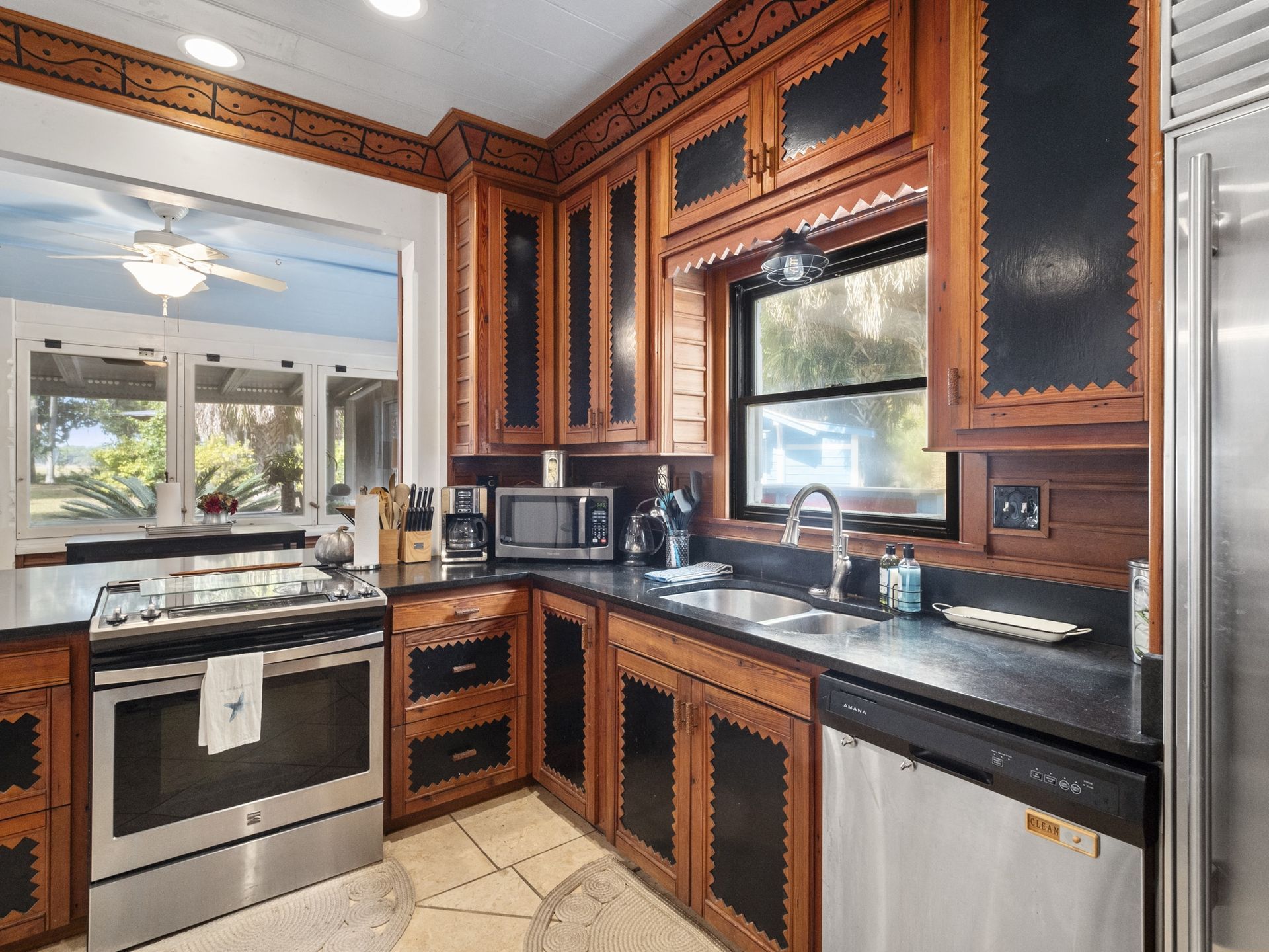 A kitchen with stainless steel appliances and wooden cabinets.