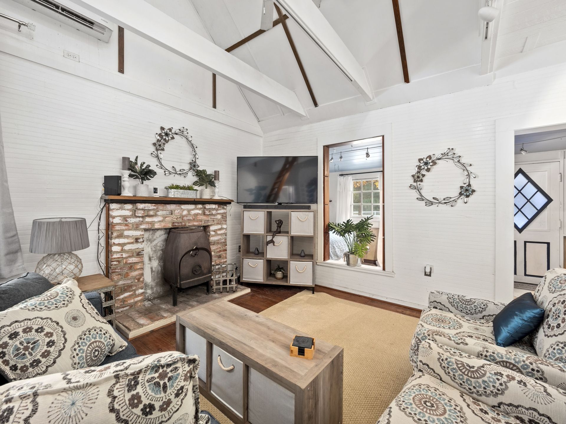 A living room with a fireplace and a flat screen tv