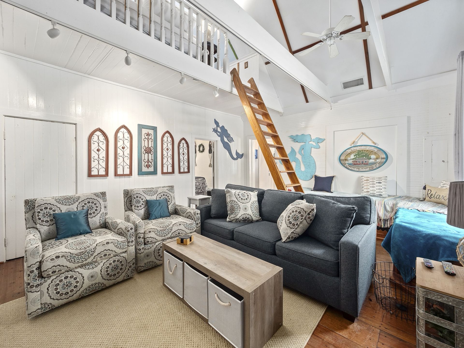 A living room with a couch , chairs , and a coffee table.