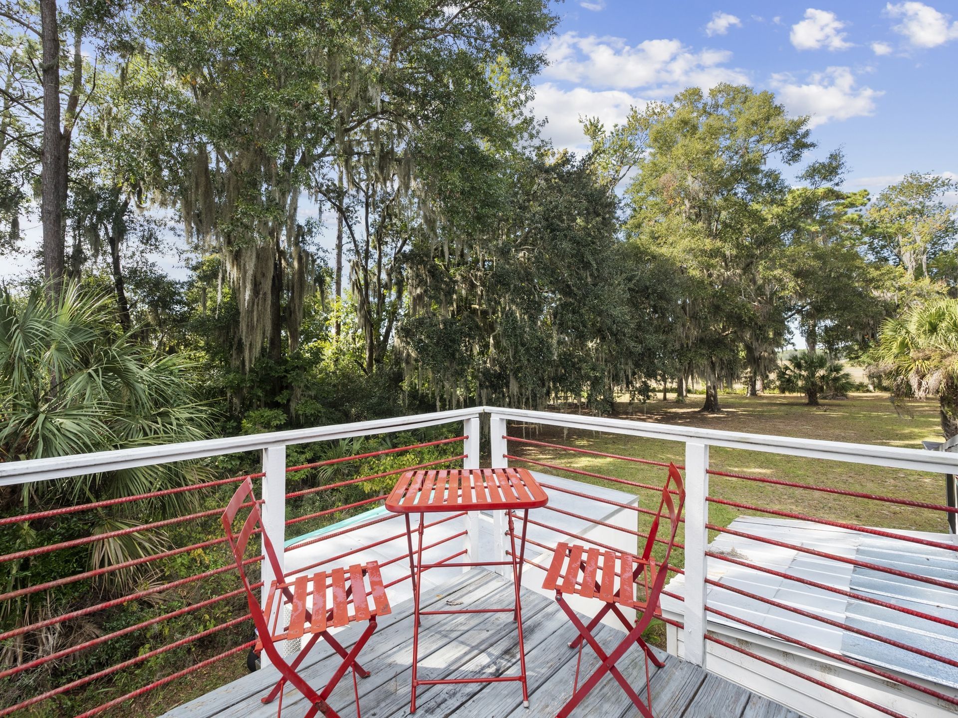 There is a table and chairs on the deck.