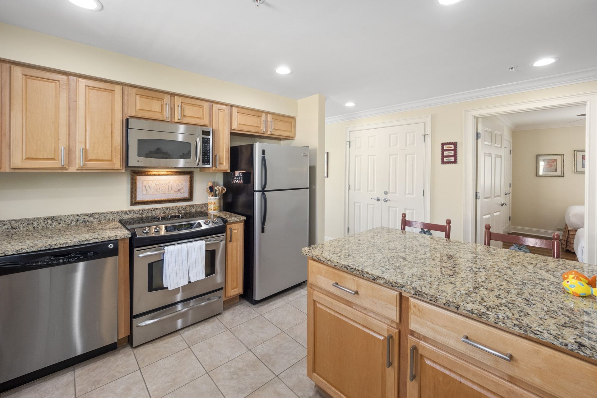 A kitchen with stainless steel appliances and granite counter tops.