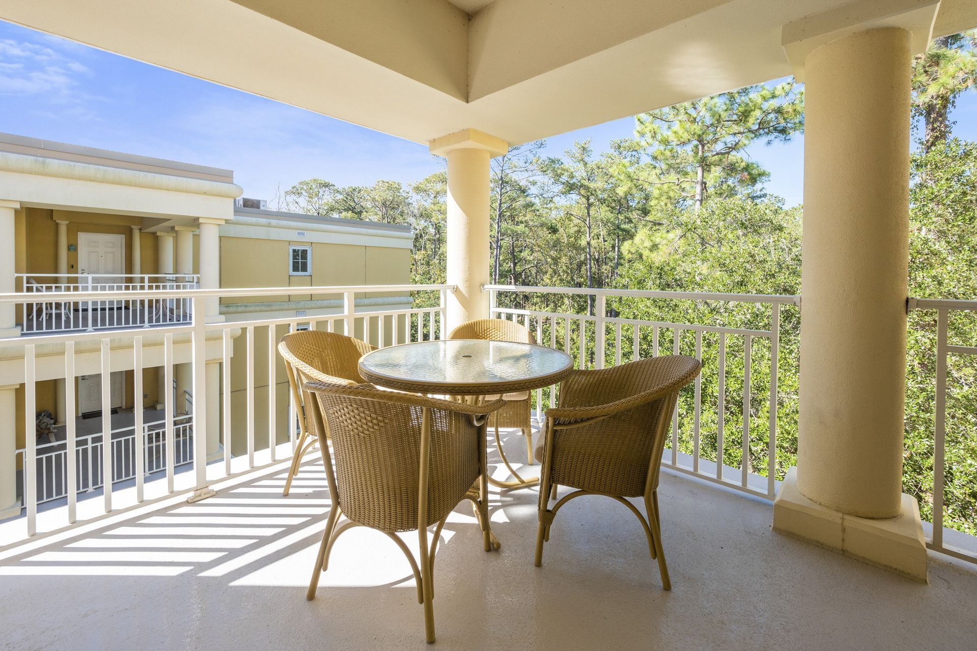A balcony with a table and chairs on it