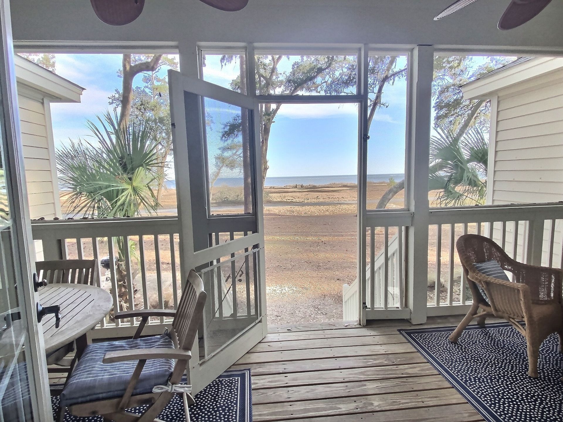 A screened in porch with a view of the ocean