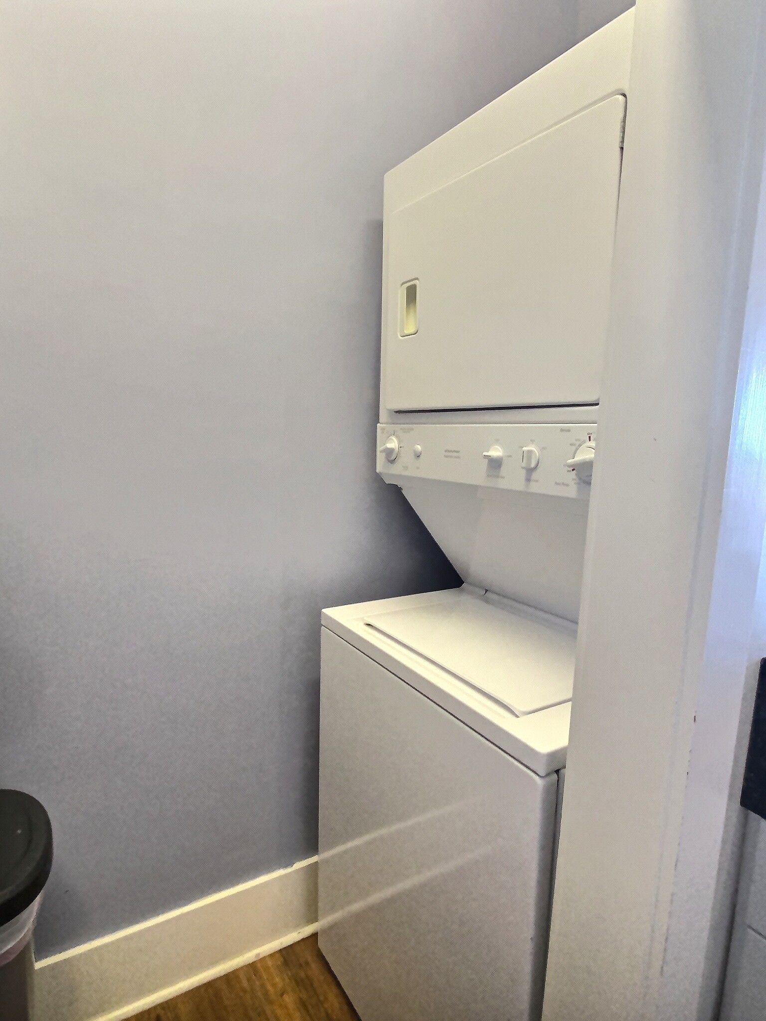A washer and dryer are stacked on top of each other in a laundry room.