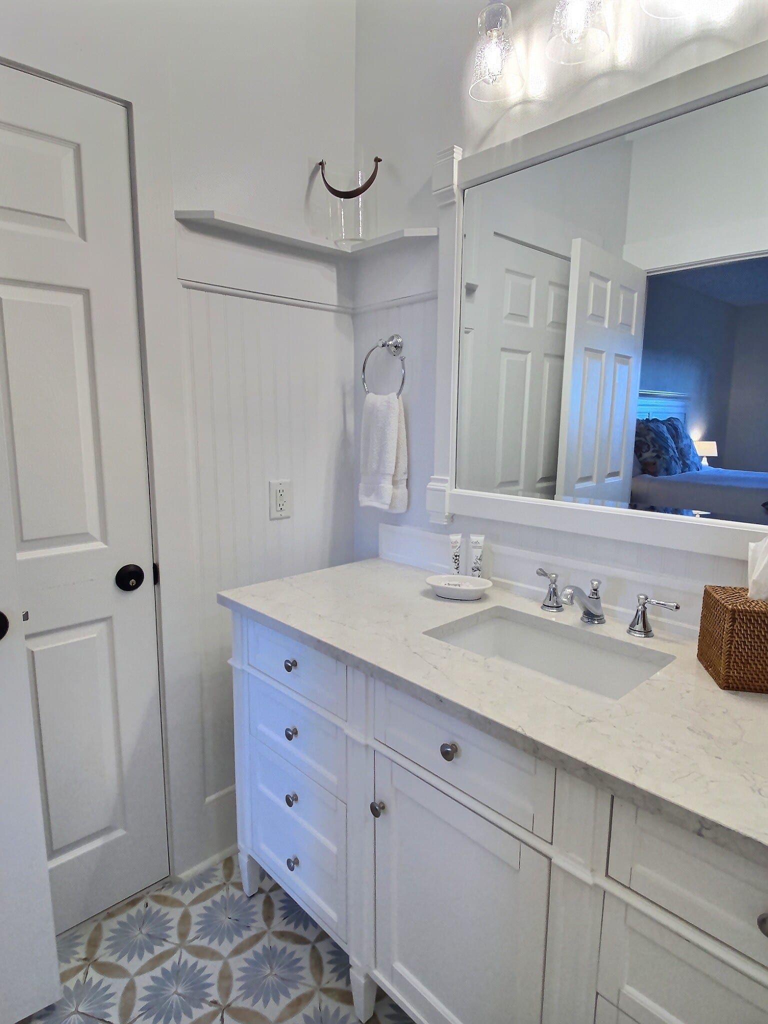A bathroom with a sink , mirror and cabinets.