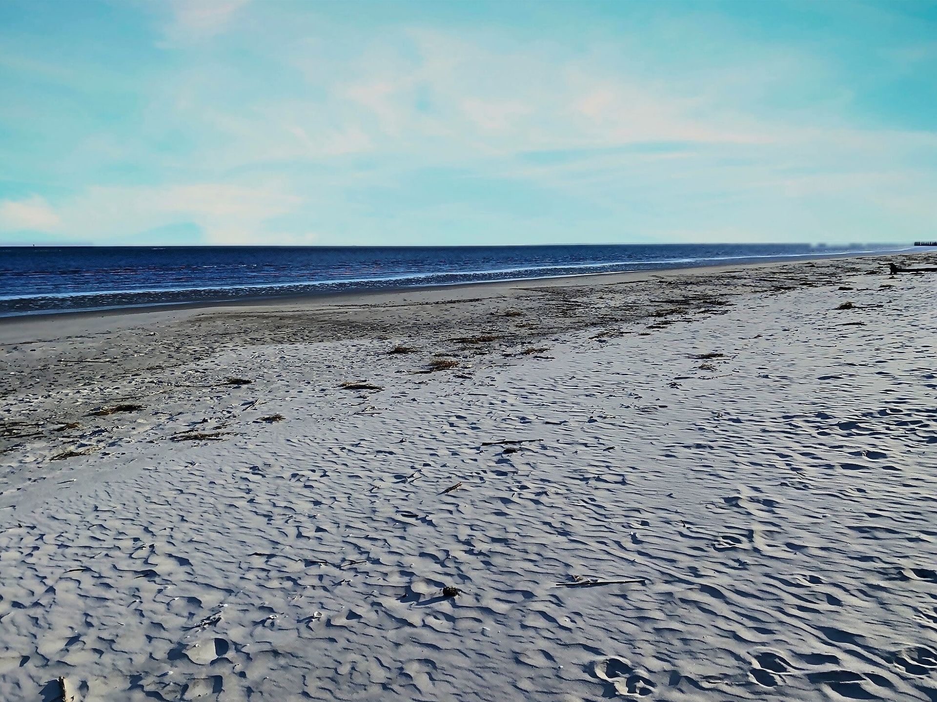 A sandy beach with the ocean in the background