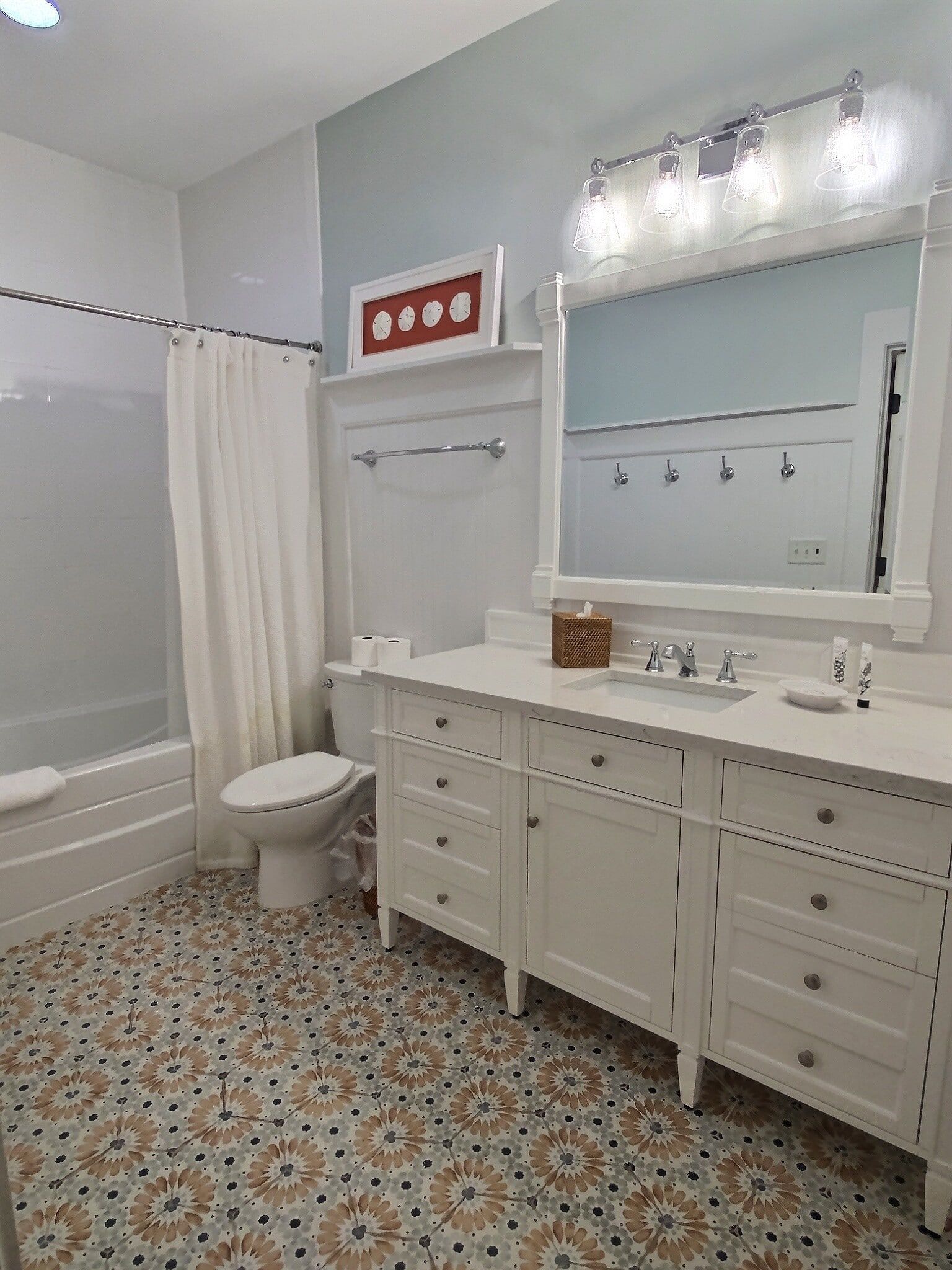 A bathroom with a toilet , sink , mirror and bathtub.