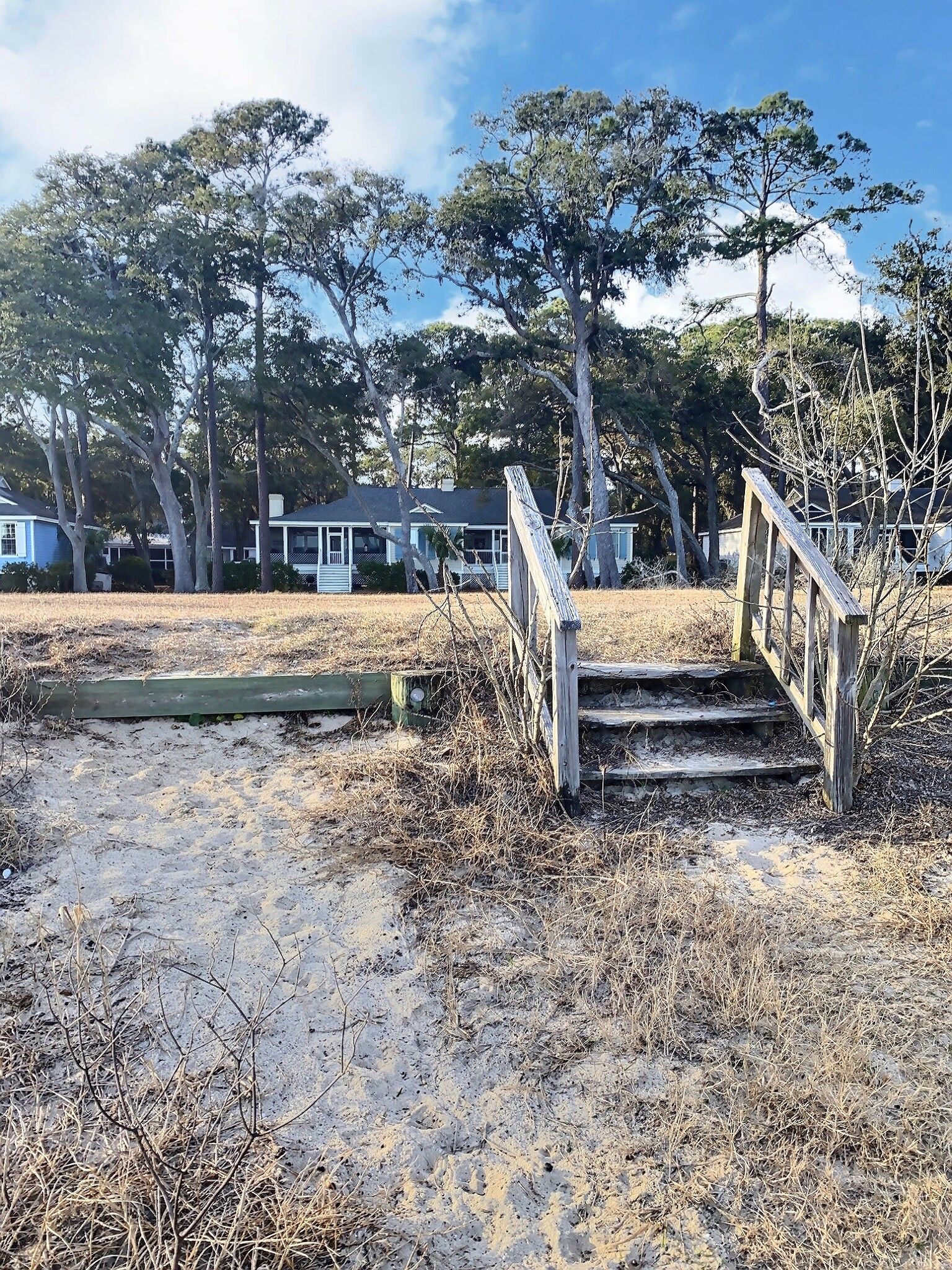 There are stairs leading up to a house in the background.