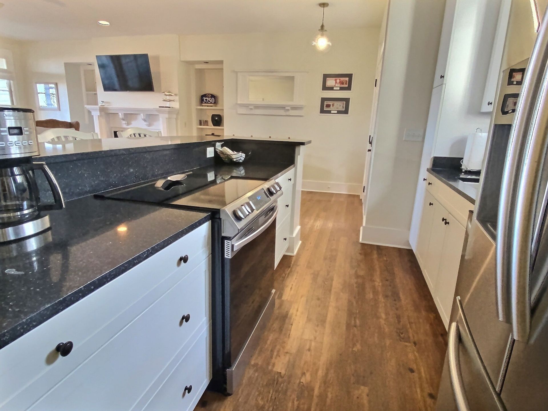 A kitchen with stainless steel appliances and black counter tops
