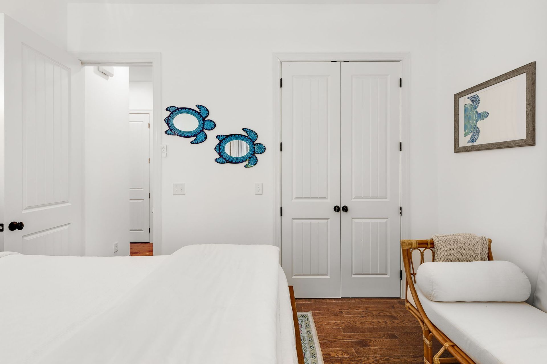 A bedroom with two beds , a couch , and a closet.