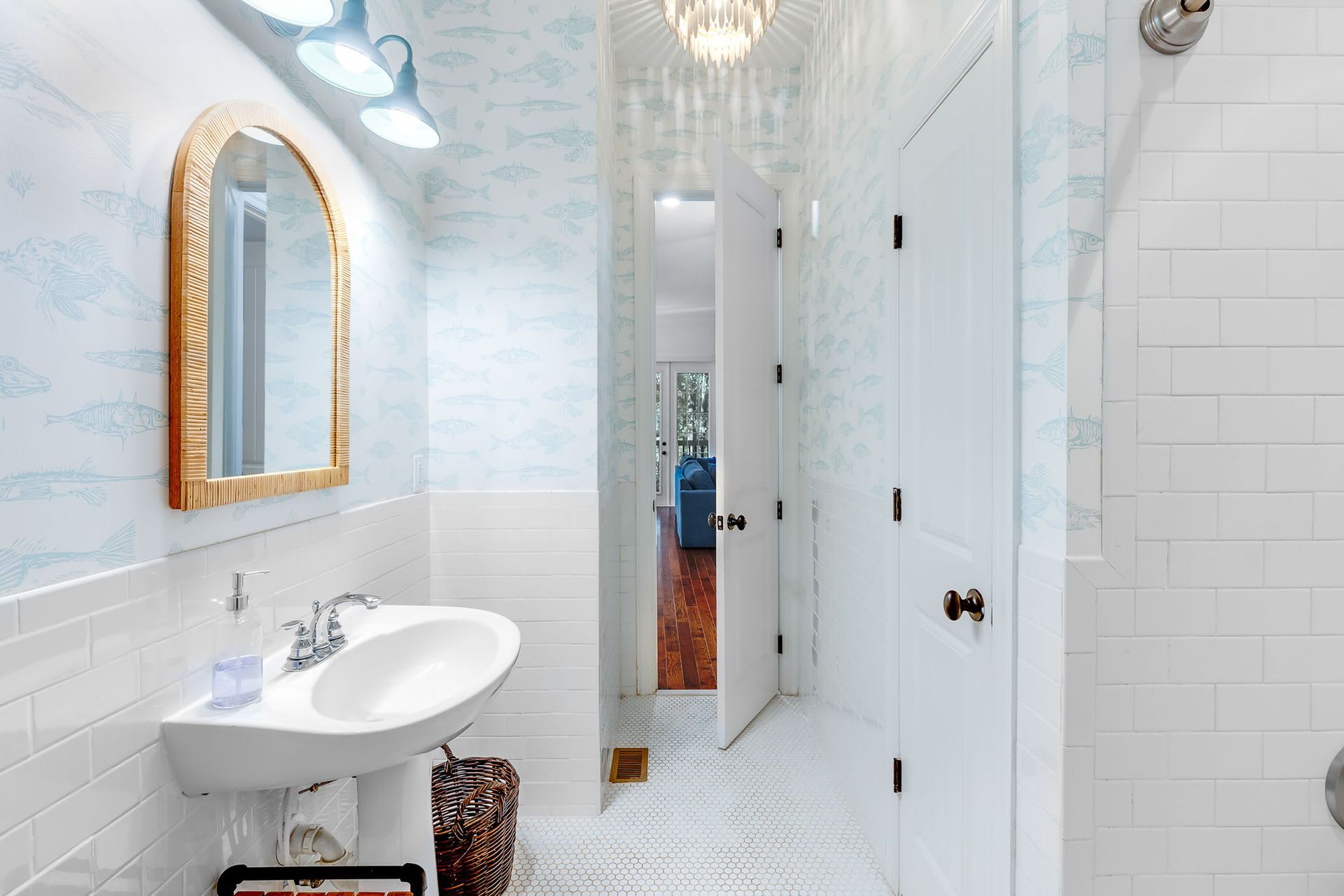 A bathroom with a sink , mirror and shower.