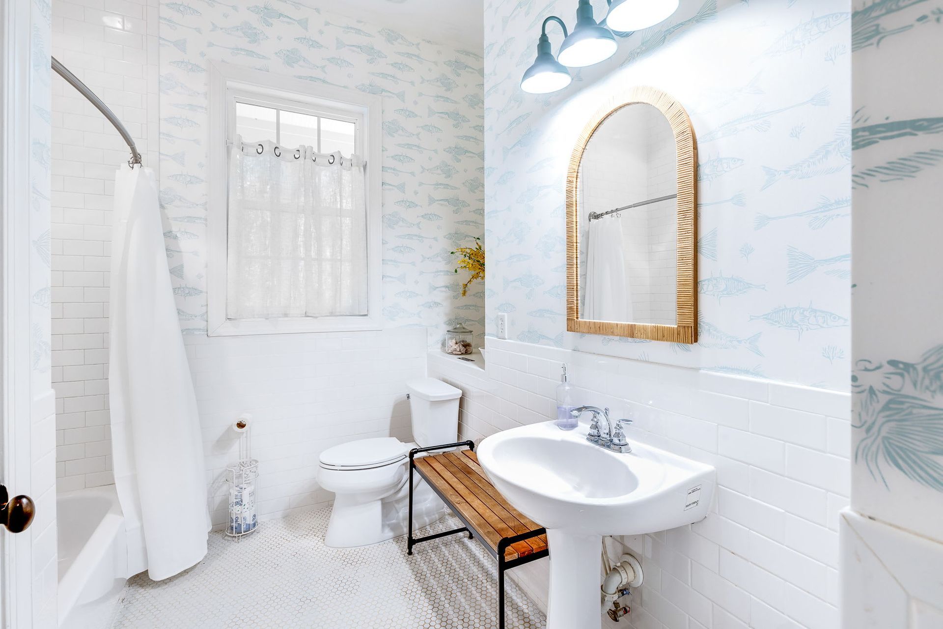 A bathroom with a toilet , sink , and mirror.