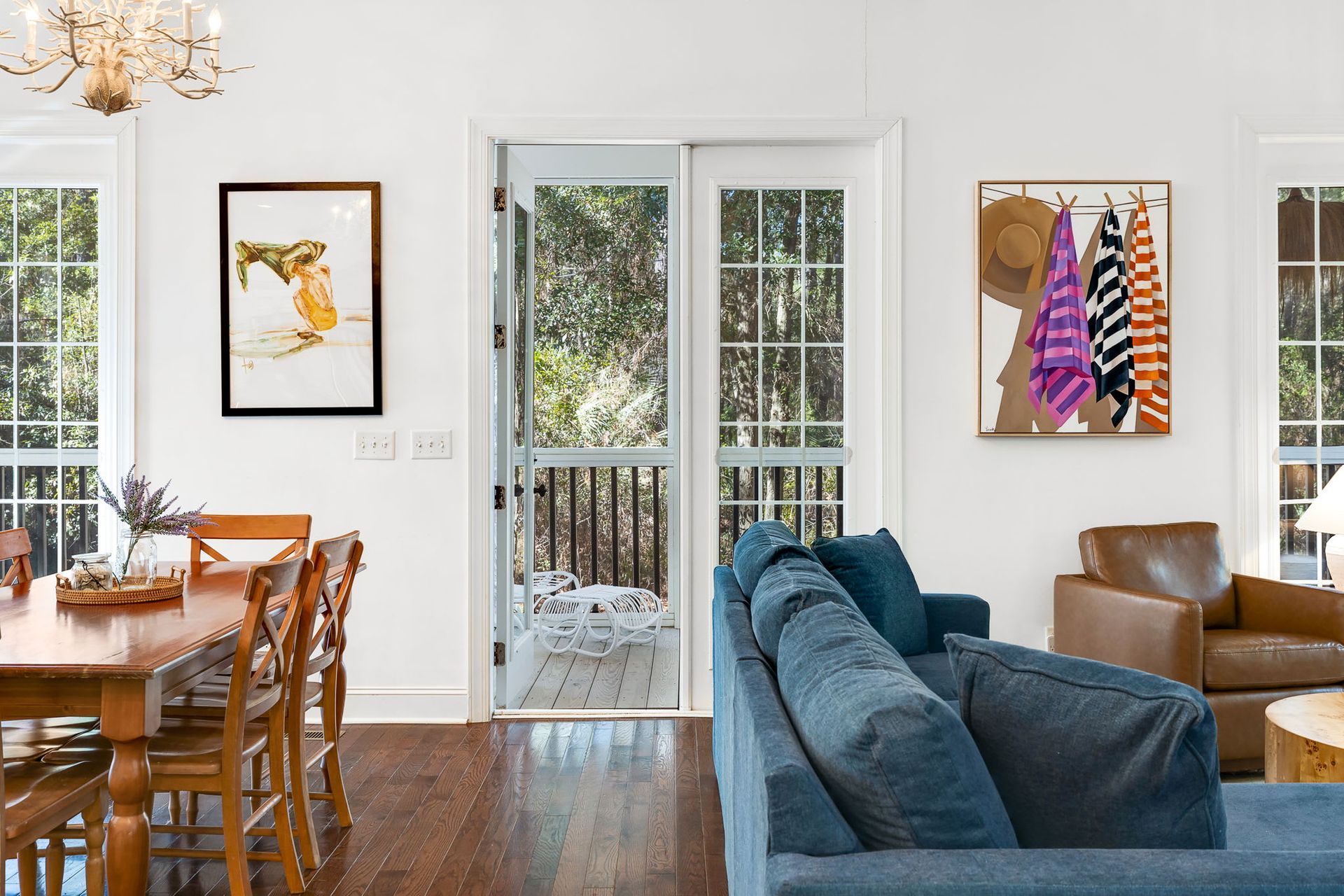 A living room with a blue couch and a dining table