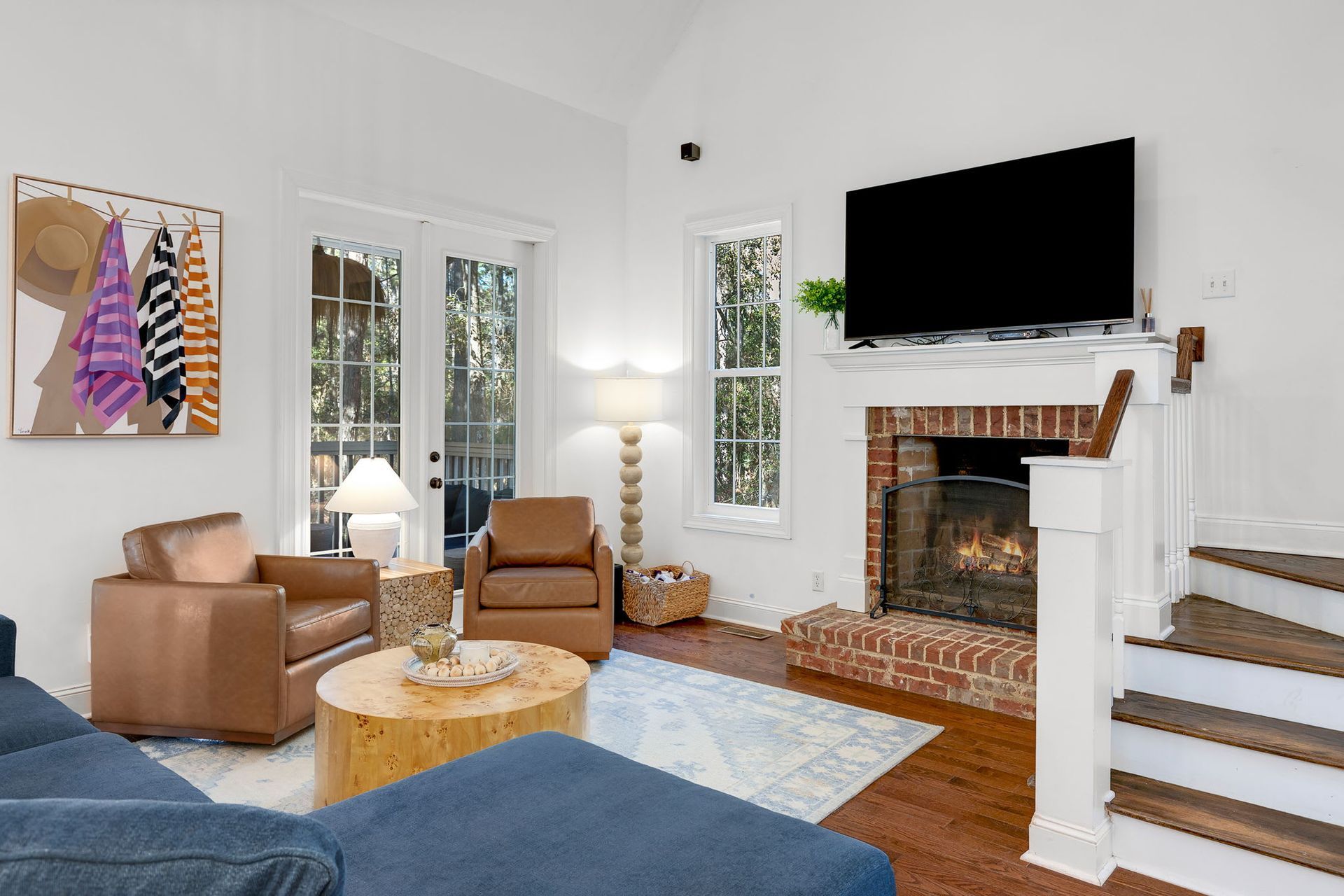 A living room with a fireplace and a flat screen tv