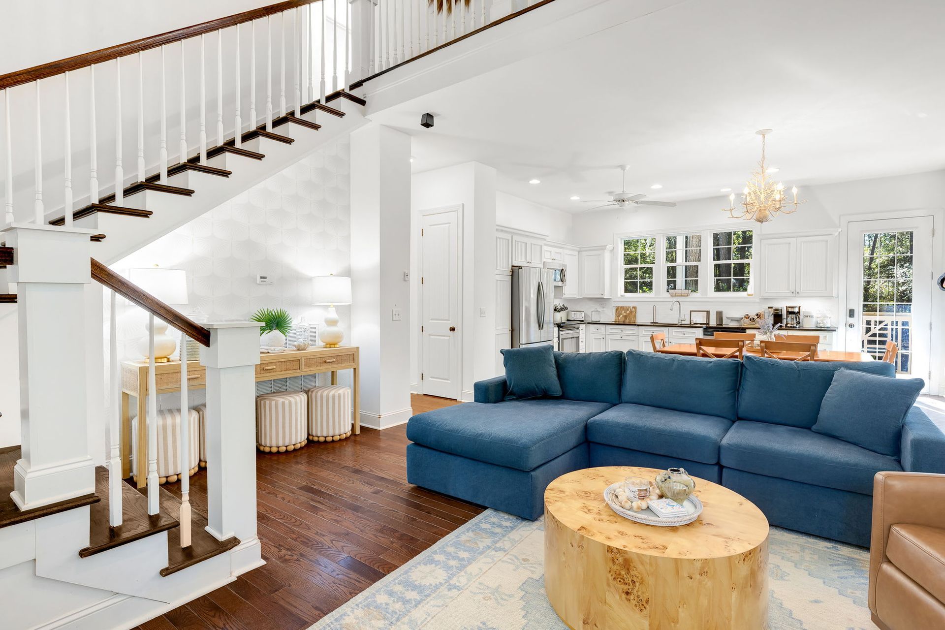 A living room with a blue couch and a wooden coffee table.