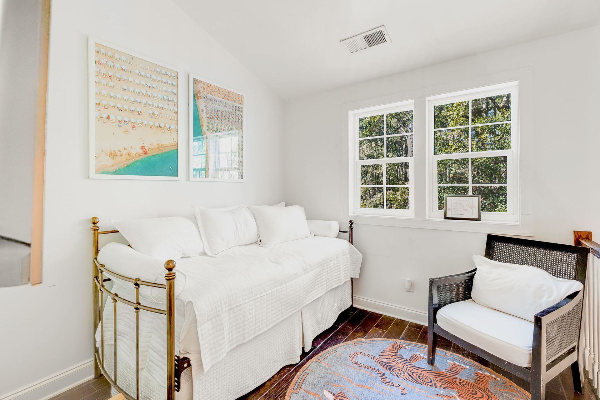 A bedroom with a day bed and a chair.