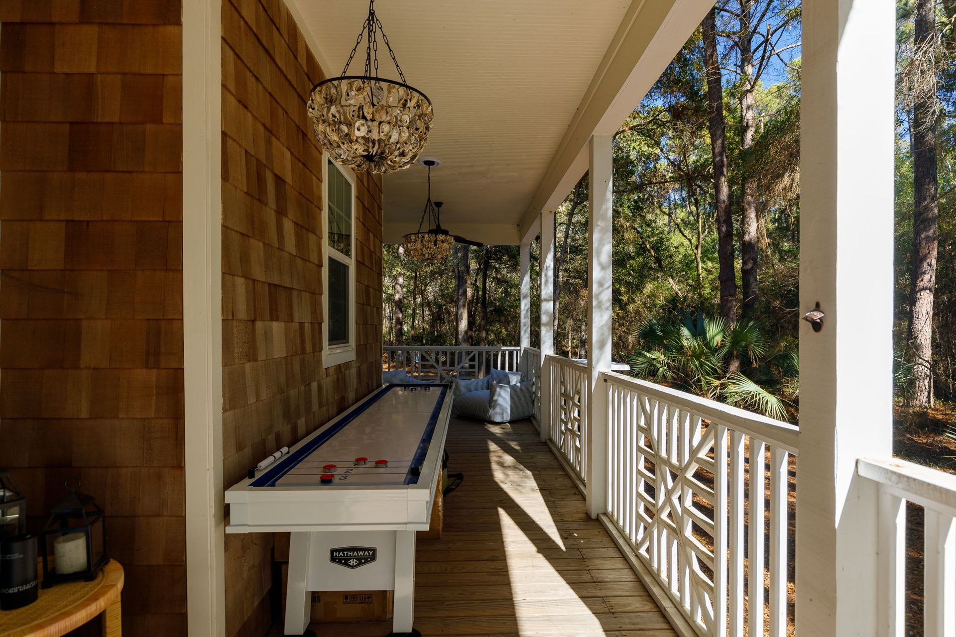 There is a shuffleboard table on the porch of a house.