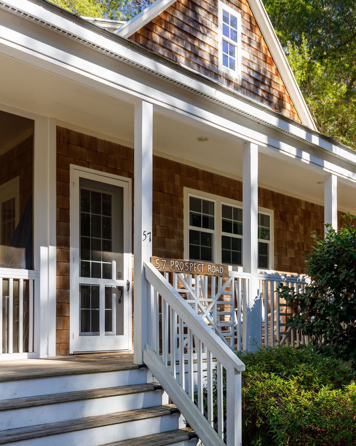 A house with a porch and stairs leading up to it