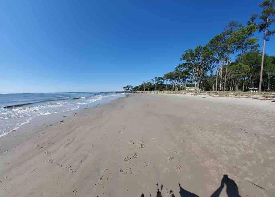 A living room with a fireplace , stairs and a flat screen tv.