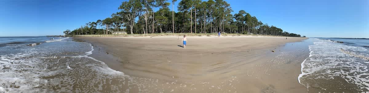 A living room with a blue couch and a wooden coffee table.