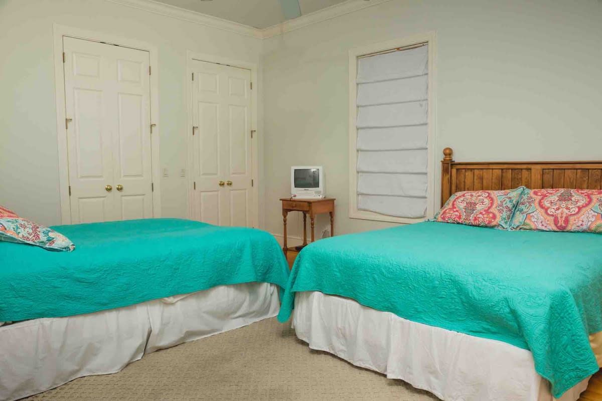A kitchen with stainless steel appliances and white cabinets.