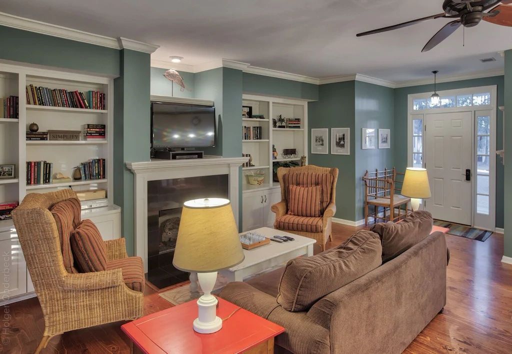 A living room with a couch and chairs and a fireplace
