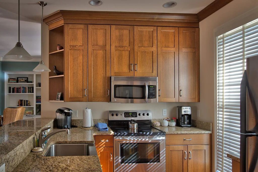 A kitchen with stainless steel appliances and wooden cabinets