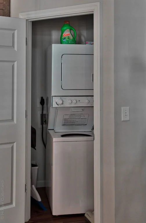 A washer and dryer are stacked on top of each other in a closet.