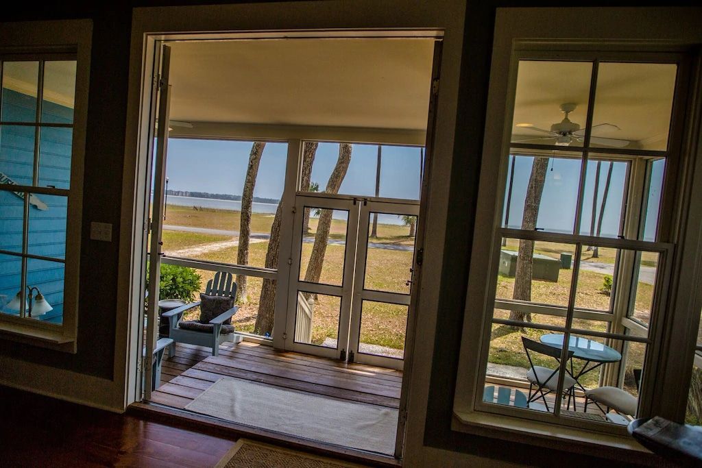 A living room with a view of the ocean through the windows.