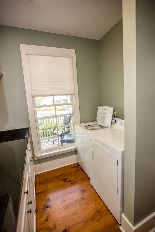 A laundry room with a washer and dryer and a window.